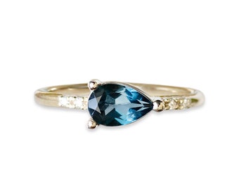 pear london blue topaz and diamond ring, sideways pear, made with SCS recycled 14k and 18k gold