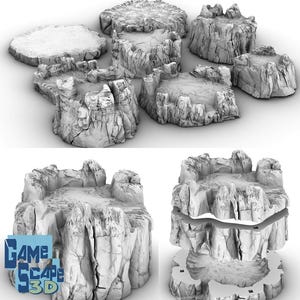 May include: A collection of gray, 3D-printed terrain pieces designed for tabletop gaming. The set includes various rock formations with detailed textures, including platforms and cliffs. The Game Scape 3D logo is visible in the lower left corner.