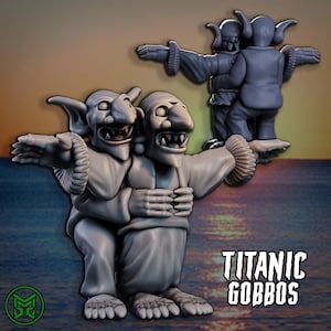 May include: A grey 3D-printed figurine of two goblin-like creatures embracing, with arms outstretched. A third figure is in the background. The figures have large noses, pointed ears, and open mouths. The text "TITANIC GOBBOS" is displayed in a stylized font.