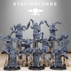 May include: A group of grey miniature figures, each wearing a hooded robe and with mechanical arms. Some figures hold books or weapons. The figures are displayed on clear stands. The text "STATIONFORGE" and a skull logo are at the top.