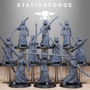 May include: A collection of gray miniature figures, each with a hooded cloak and staff, arranged on small platforms. The figures have detailed facial features and are posed in various stances. The text "STATIONFORGE" is displayed at the top of the image.