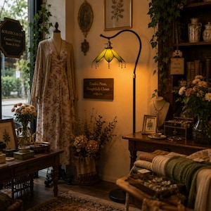 Botanical stained glass floor lamp in a vintage boutique featuring handmade green glass shade, curved arm design and warm ambient lighting