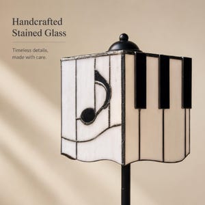 Close-up detail of handcrafted stained glass lampshade with music note and piano key design