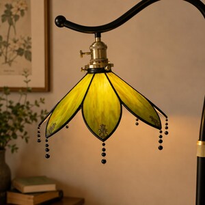 Close-up of Handmade Green Stained Glass Lampshade with Antique Brass Socket and Decorative Beaded Details