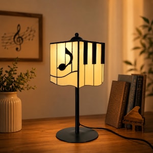Music note bedside lamp with piano key stained glass shade on wooden table