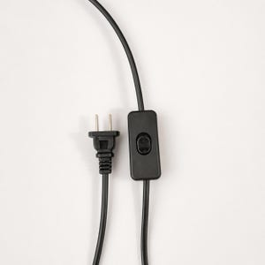 Black plug-in power cord with inline switch for the piano stained glass table lamp.