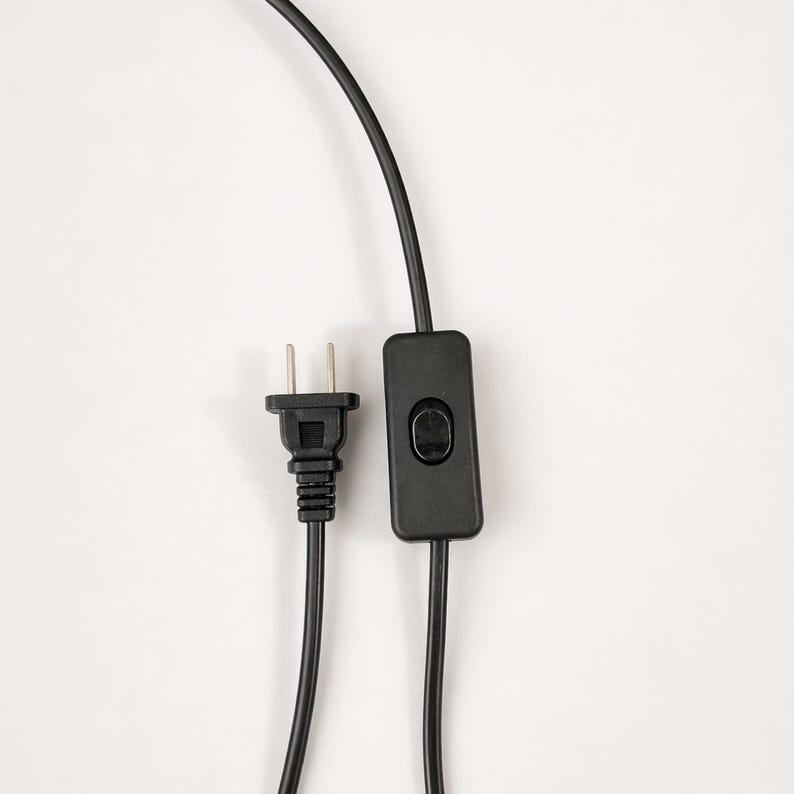 Black plug-in power cord with inline switch for the piano stained glass table lamp.