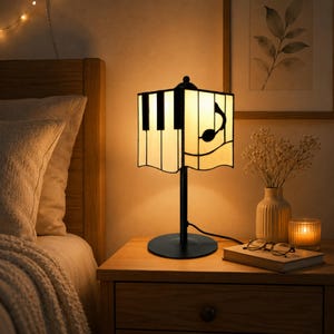 Bedside table scene with piano stained glass lamp creating a soft warm glow for nightstand decor