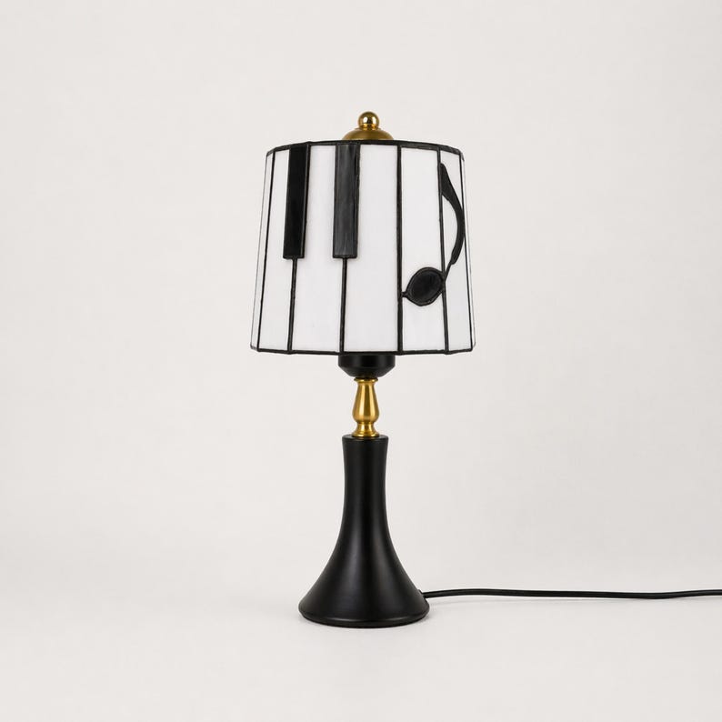 Comparison of the piano stained glass table lamp turned on and off, showing warm glow and natural white glass color.