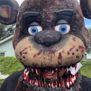 Withered Freddy Fazbear with Sharp teeth and glowing eyes