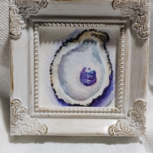 May include: A watercolor painting of an oyster shell with purple and blue hues, framed in a white ornate frame.
