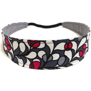 May include: A fabric headband with a floral pattern in white, gray, and red. The headband has a gray interior and a black elastic band. The design features a repeating pattern of stylized leaves.