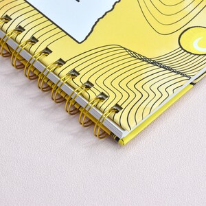 Up close view of the double gold binding with details of the color yellow and swirl design.