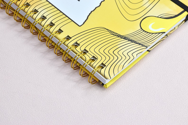 Up close view of the double gold binding with details of the color yellow and swirl design.