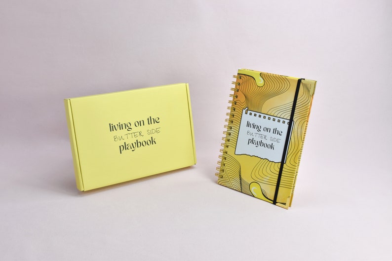 Front view of yellow guided journal, yellow, custom box. Journal enhanced with gold binding, gold corners, elastic holder.