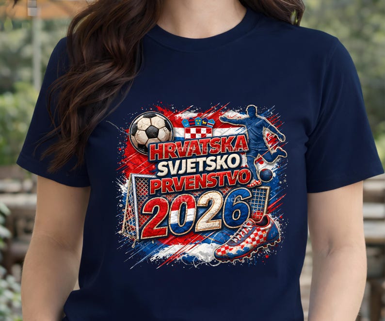 May include: Navy blue t-shirt with a soccer-themed graphic. The design includes a soccer ball, a player kicking a ball, a soccer shoe, and the text "HRVATSKA SVJETSKO PRVENSTVO 2026" in red, white, and blue.