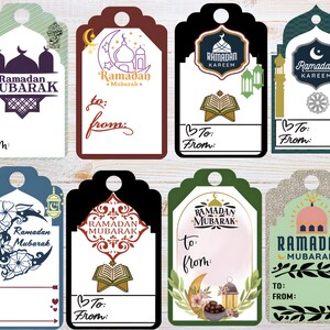 May include: A collection of eight Ramadan Mubarak gift tags in various designs. The tags feature mosque and crescent moon illustrations, along with the phrases "Ramadan Mubarak" and "Ramadan Kareem". Each tag includes space to write "To" and "From".