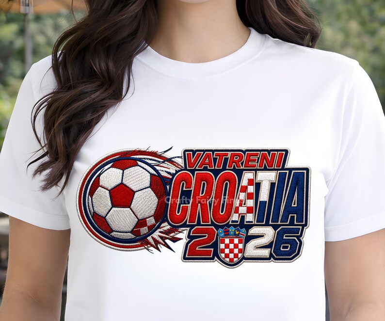 May include: White t-shirt featuring a soccer ball design with red and white accents, and the text "VATRENI CROATIA 2026". The design includes the Croatian flag colors and a shield emblem.