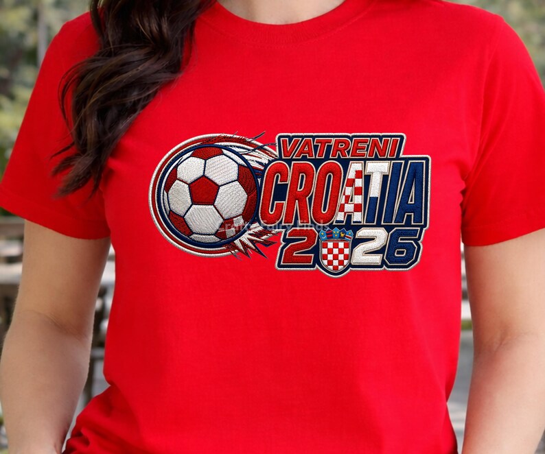 May include: Red t-shirt with a soccer ball graphic and the text "VATRENI CROATIA 2026". The design features the Croatian flag colors and a soccer ball with a fiery trail.