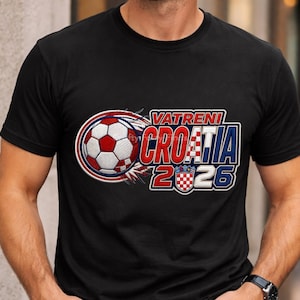 May include: Black t-shirt featuring a soccer ball design with the text "VATRENI CROATIA 2026". The design includes the Croatian flag colors of red, white, and blue. The soccer ball is red and white.