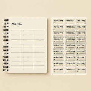 May include: A cream-coloured spiral-bound notebook labelled "AGENDA". Beside it are rectangular stickers, each printed with "RENDEZ-VOUS" and the letter "A". The notebook's pages are lined for scheduling.