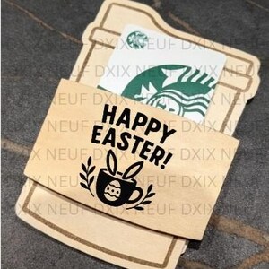May include: A wooden gift card holder with the words "HAPPY EASTER!" and a graphic of a coffee cup with bunny ears. A Starbucks gift card is visible inside the holder. The holder is light brown with a darker brown border.
