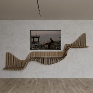 May include: A modern, wave-shaped wooden shelf unit mounted on a white wall. The shelf is made of vertical wooden slats and has a natural wood finish. A flat-screen TV is mounted on the wall above the shelf, displaying a scenic image.