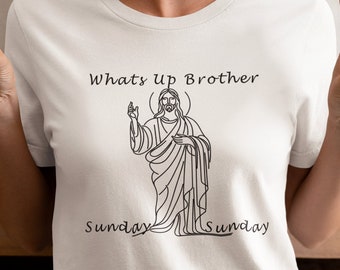 May include: White t-shirt with a black line drawing of Jesus on it. The text "Whats up Brother" is above the drawing and "Sunday Sunday" is below the drawing.
