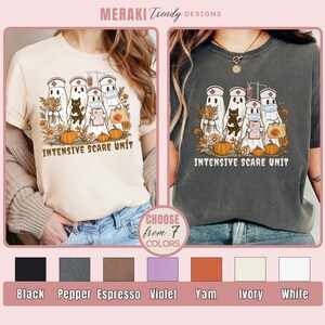 May include: Two t-shirts, one cream and one charcoal, each featuring a graphic of ghost nurses, a black cat, pumpkins, and fall foliage. The text "INTENSIVE SCARE UNIT" is below the graphic. The image also shows color options.