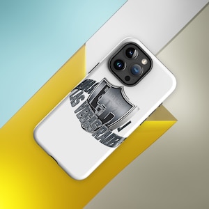 May include: White iPhone case featuring a silver Raiders logo and the text "RAIDERS LAS VEGAS RAIDERS".