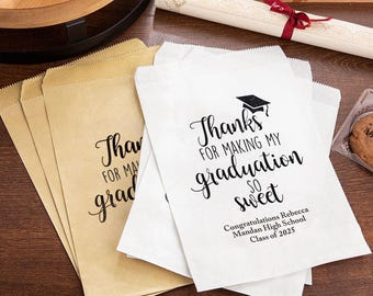 May include: White paper gift bags with black text that reads "Thanks for making my graduation so sweet."  The text is in a cursive font.  The bags also include the text "Congratulations Rebecca Mandan High School Class of 2025".