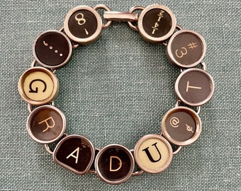 GRADUATE" Typewriter Key Bracelet: Celebrate with our one-of-a-kind bracelet crafted from typewriter keys