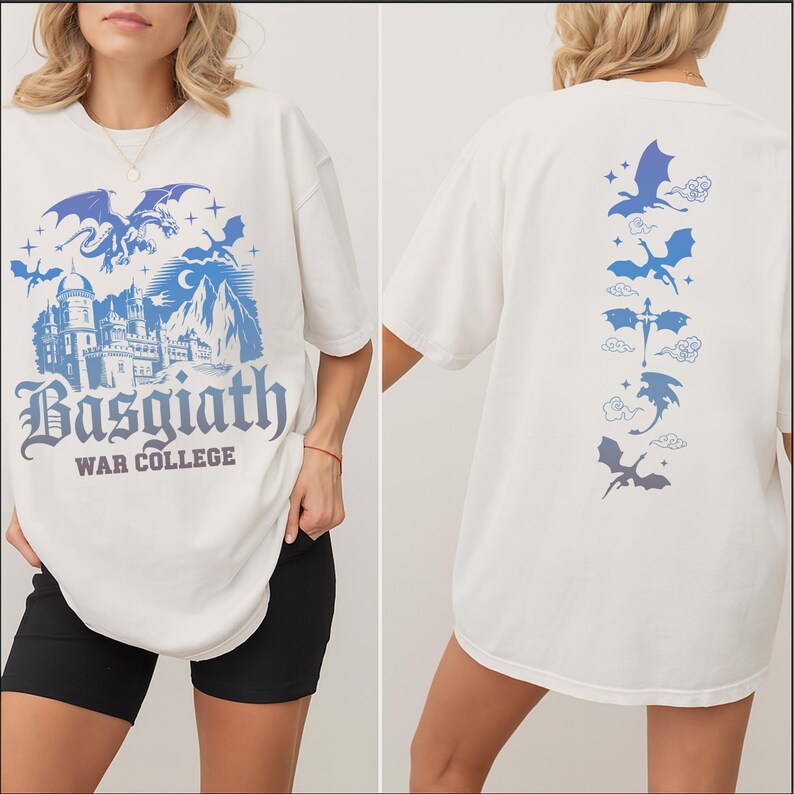 May include: Cream-colored t-shirt featuring a blue and purple graphic of a castle, dragons, and the text "Basgiath War College" on the front. The back of the shirt displays a vertical line of dragon illustrations in blue and purple.