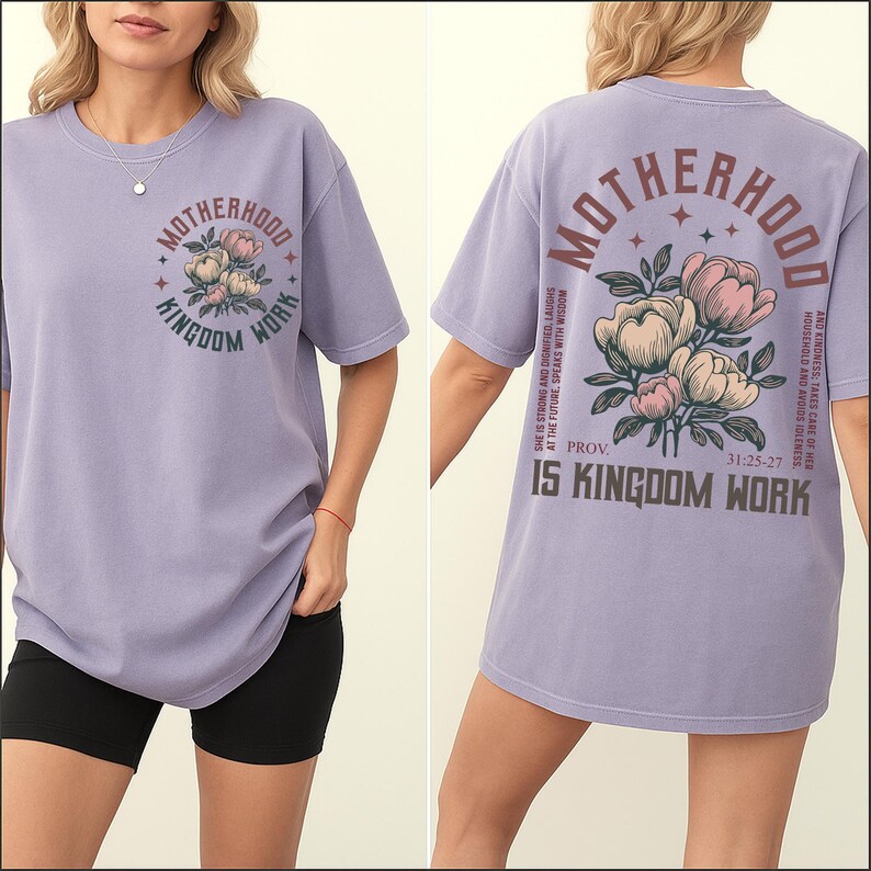 May include: Lavender short-sleeved t-shirt with the text "MOTHERHOOD IS KINGDOM WORK" and a floral design on the front. The back of the shirt features the same text and floral design, along with a Bible verse.