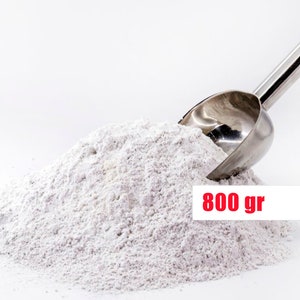 May include: A white powder in a pile with a silver scoop, labeled "800 gr".