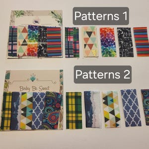 May include: An assortment of patterned ribbons, labeled "Patterns 1" and "Patterns 2." The ribbons feature various designs, including plaid, geometric shapes, and floral patterns. The "Baby Be Sweet" logo is visible on one of the cards.