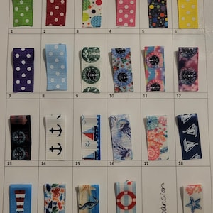 May include: A collection of 24 ribbon hair clips with various patterns. Designs include polka dots, anchors, sailboats, jellyfish, and floral prints. Colors range from green, red, and blue to pink, yellow, and purple. Each clip is approximately 2 inches long.