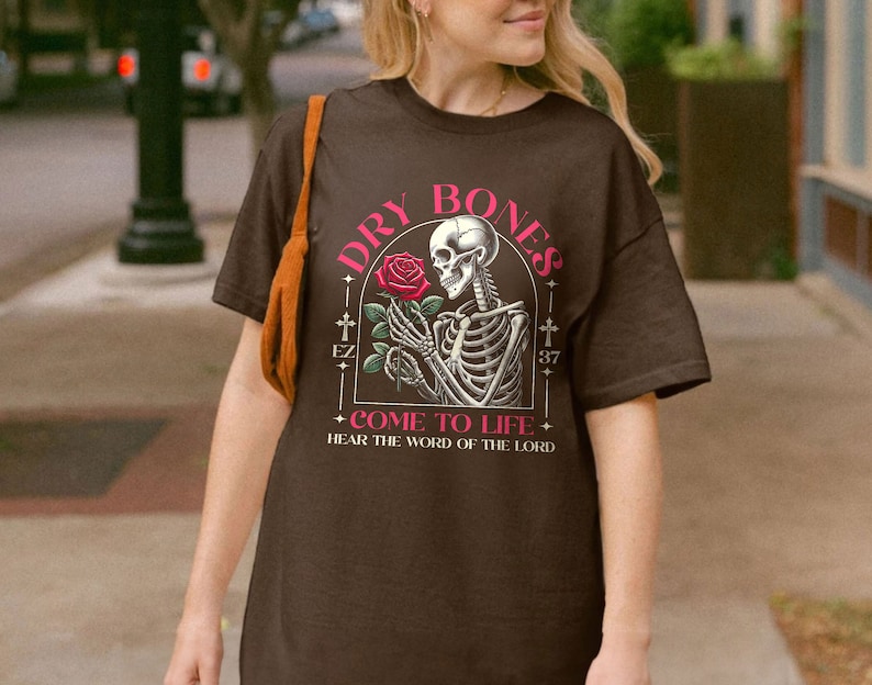 May include: Brown t-shirt with a graphic of a skeleton holding a rose and the text "Dry Bones Come to Life Hear the Word of the Lord"