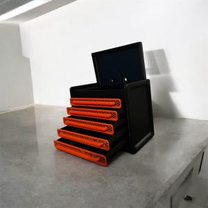 May include: A black toolbox with five orange drawers. The top drawer is open and the lid is propped up.