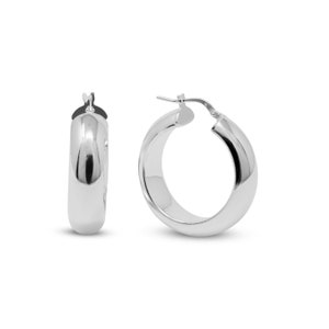 Peut inclure: Une paire de boucles d'oreilles créoles en argent avec une surface lisse et arrondie. Les boucles d'oreilles mesurent environ 2,5 cm de diamètre.
