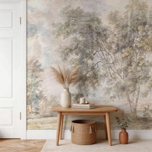 May include: A room featuring a mural of a landscape scene with trees and a cloudy sky. A wooden bench holds a vase with dried plants, books, and a candle. A woven basket and a terracotta vase with greenery are also present.