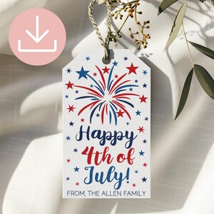 May include: A rectangular white gift tag with a hole at the top and a jute twine loop. The tag features a red and blue firework graphic, red and blue stars, and the text "Happy 4th of July!" in blue and red, with "FROM, THE ALLEN FAMILY" below.