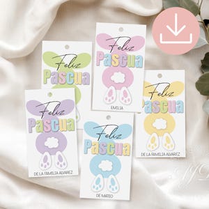 May include: Five pastel colored Easter gift tags with bunny ears and the text "Feliz Pascua" in black. The tags are decorated with clouds and the names "Emilia", "De la familia Alvarez", and "De Mateo".