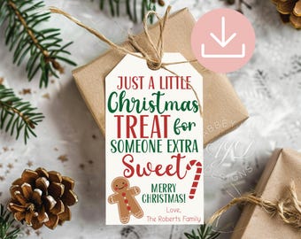 May include: A rectangular white gift tag with red and green text reading Just a Little Christmas Treat for Someone Extra Sweet Merry Christmas Love The Roberts Family, featuring a gingerbread man graphic and a red and white candy cane.