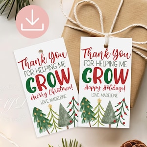 May include: Two white gift tags with the text "Thank You For Helping Me Grow" in red and green. The tags have a Christmas tree design at the bottom and are tied to a wrapped gift with twine.