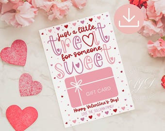 May include: A pink and white gift card with the text "Just a little treat for someone sweet" and "Gift Card". The card also has the text "Happy Valentine's Day! Love the Sullivan Family" and is decorated with small pink hearts.