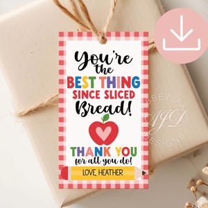May include: Red and white gingham gift tag with the text "You're the BEST THING SINCE SLICED Bread!" in rainbow letters. A red apple with a white heart is below the text. The tag also says "THANK YOU for all you do! LOVE, HEATHER".