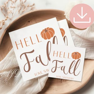 May include: White cards with the text "Hello Fall" in brown script and a pumpkin graphic. The cards are arranged on a wooden bowl with a white cloth. The text "Love, Savannah" is also included.