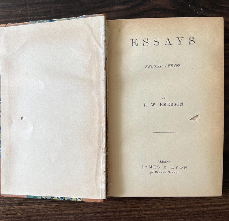 May include: A vintage book titled "Essays, Second Series" by R.W. Emerson. The book is published by James B. Lyon in Albany, New York.