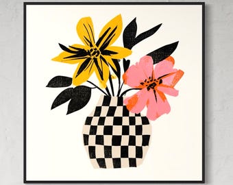 May include: A square framed wall art print featuring a graphic illustration of a bouquet of flowers in a black and white checkered vase. The arrangement includes a large yellow flower, a pink flower, and several solid black leaves on a cream background.